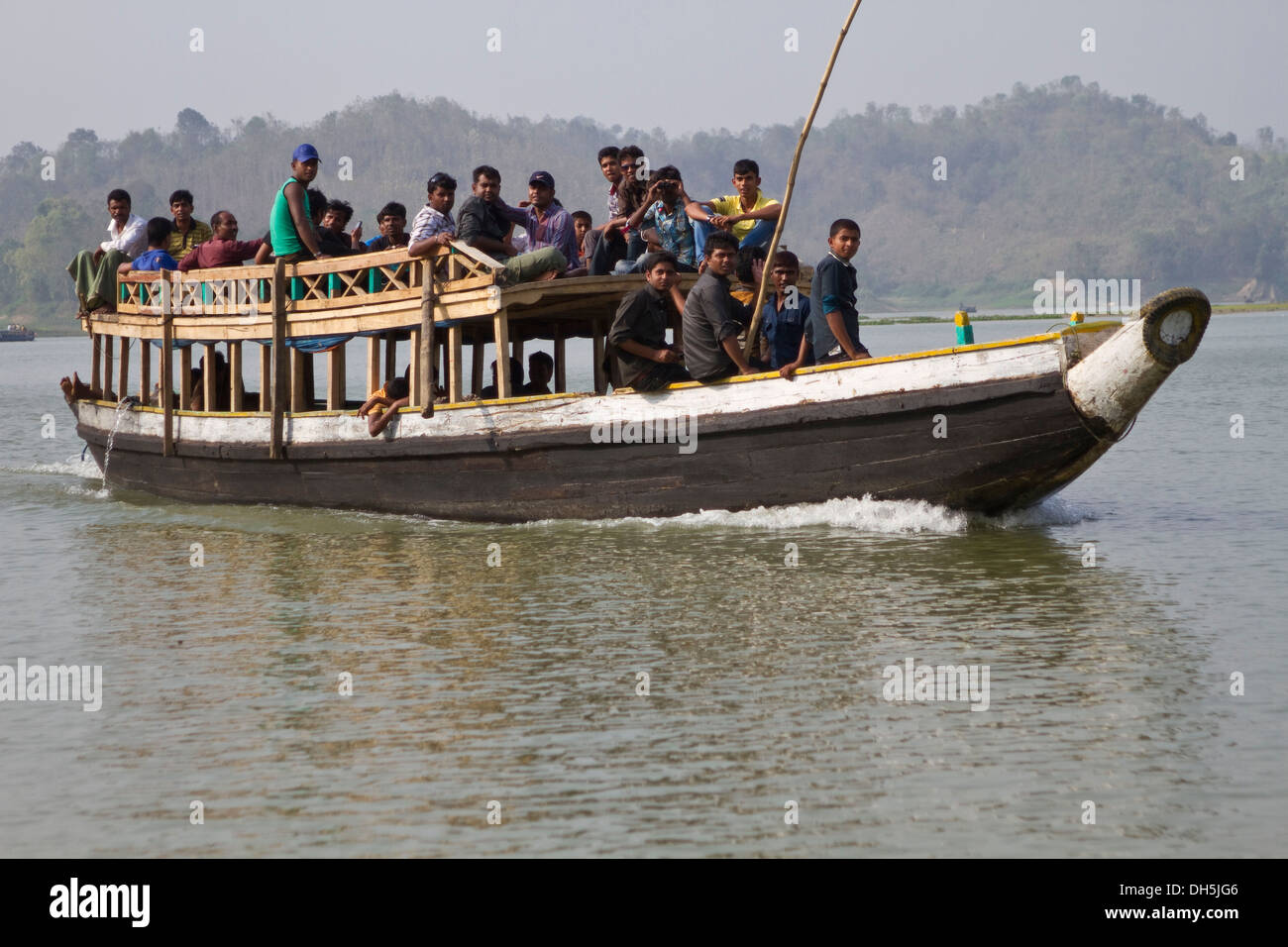 People sitting on the roof of a ferry boat, Kaptai Lake, Rangamati, Chittagong Hill Tracts, Bangladesh, South Asia, Asia Stock Photo