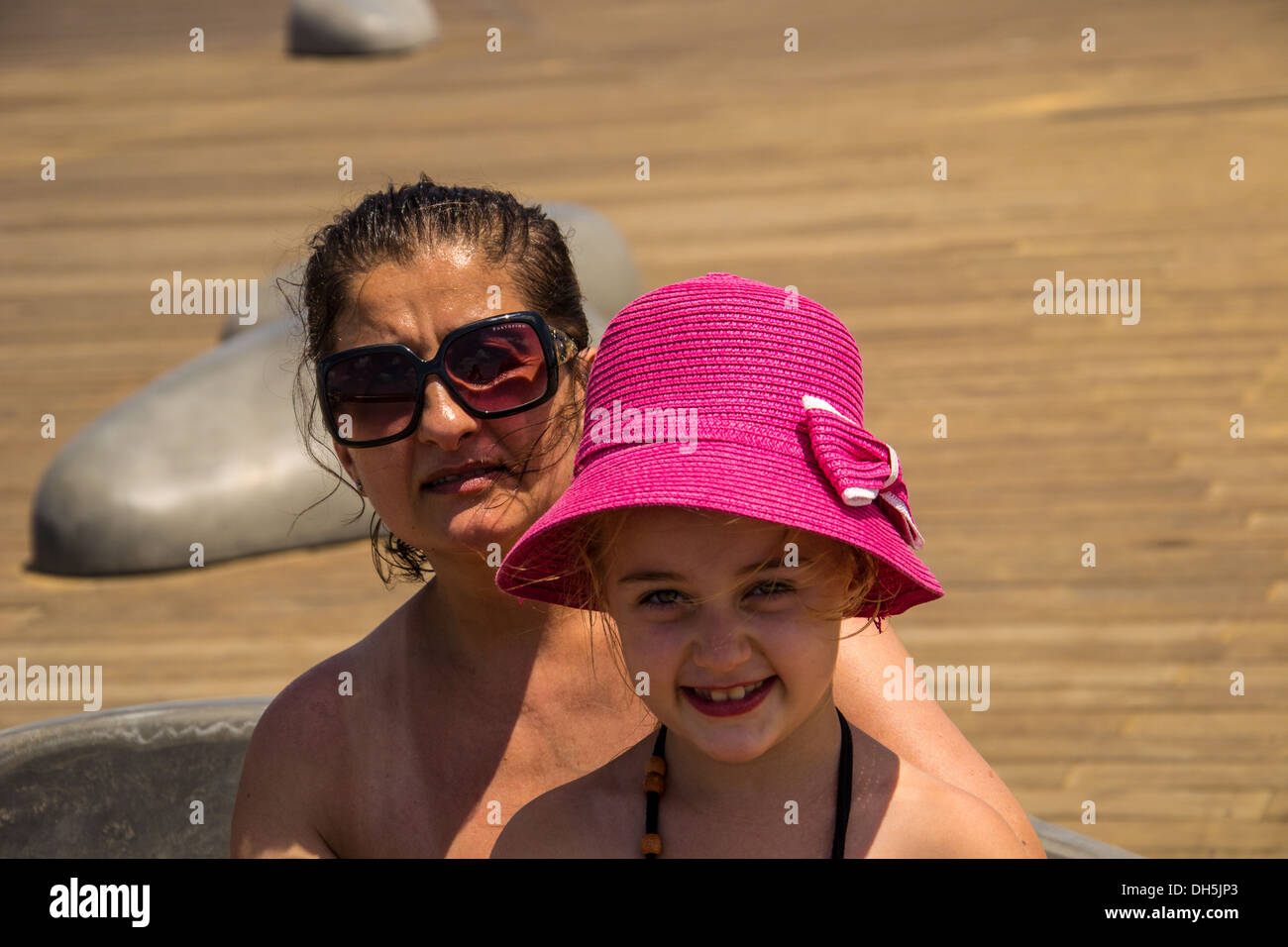 Happy Little Girl With Her Mom Outside On Summer Day Stock Photo