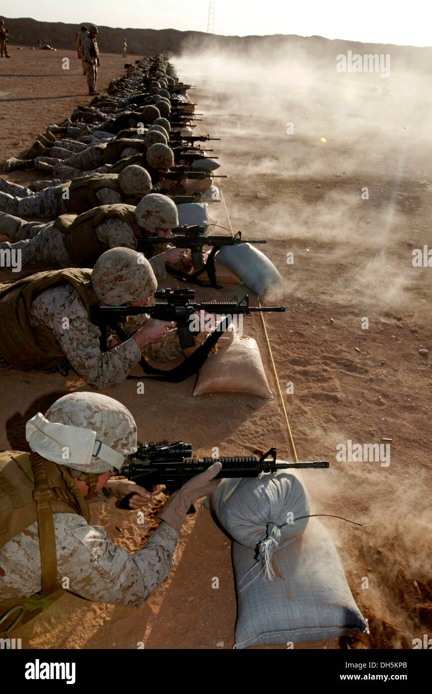 U.S. Marines with Headquarters, 2nd Marine Aircraft Wing (Forward) fire their M16/M4 service rifles during a Battle Sight Zero (BZO) range at Camp Leatherneck, Helmand province, Afghanistan, Oct. 25, 2013. A BZO was performed to maintain proficiency with Stock Photo