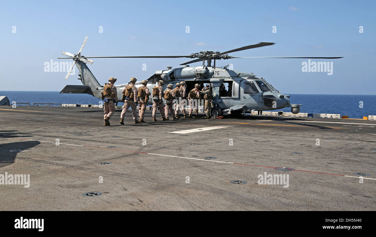 U.S. Marines with Battalion Landing Team 1/4 (BLT), 13th Marine Expeditionary Unit (MEU) conduct fast rope training aboard USS Boxer (LHD 4) Oct. 27, 2013. 13th MEU is deployed with the Boxer Amphibious Ready Group as a theater reserve and crisis response Stock Photo