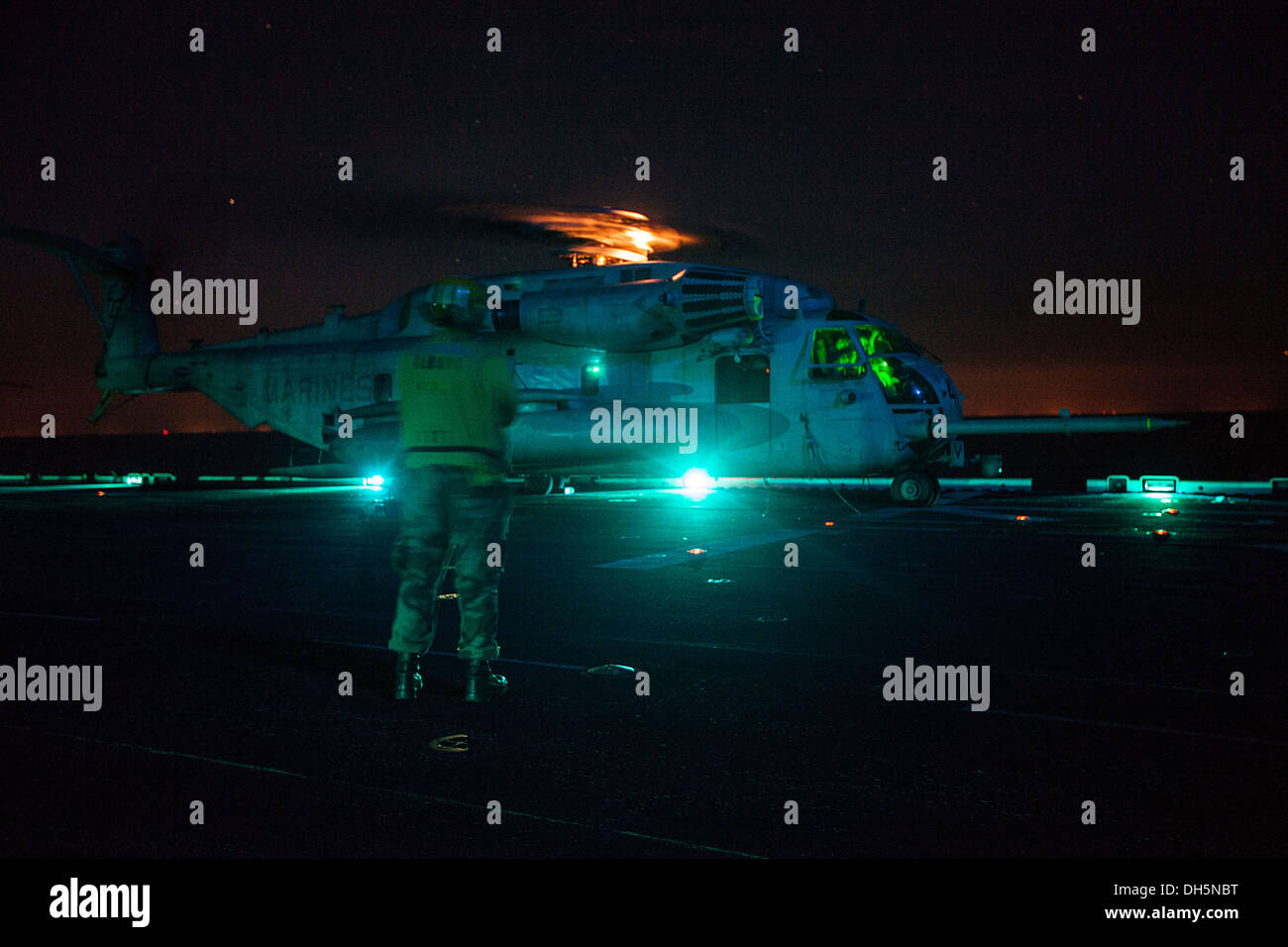 A CH-53E Super Stallion helicopter with the 22nd Marine Expeditionary Unit (MEU) prepares for takeoff aboard the USS Bataan (LHD 5) off the East Coast during a reconnaissance and surveillance exercise Oct. 27, 2013. The MEU is currently taking part in the Stock Photo