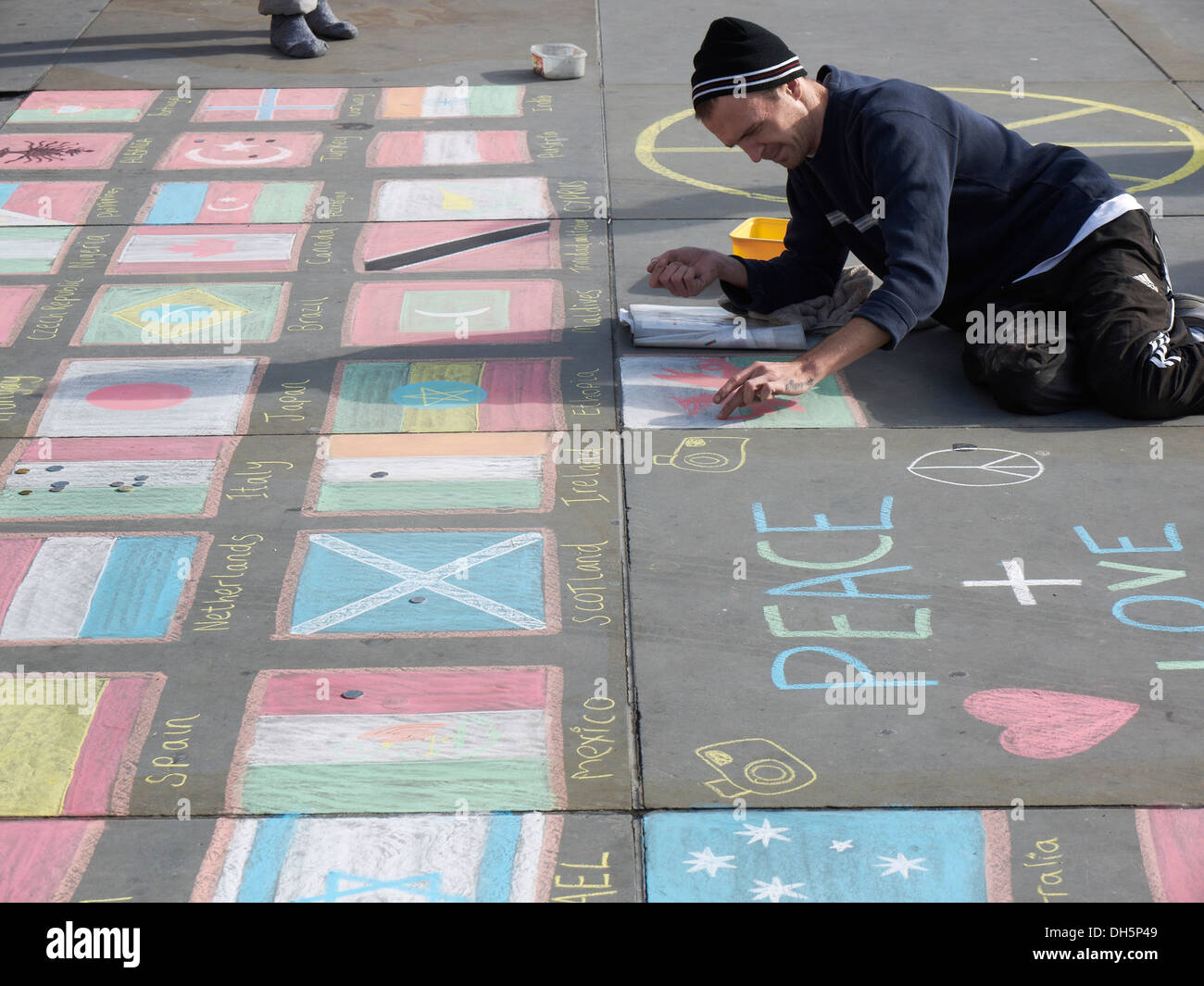 Street pavement artists drawing Flags on the floor Trafalgar Square London Stock Photo