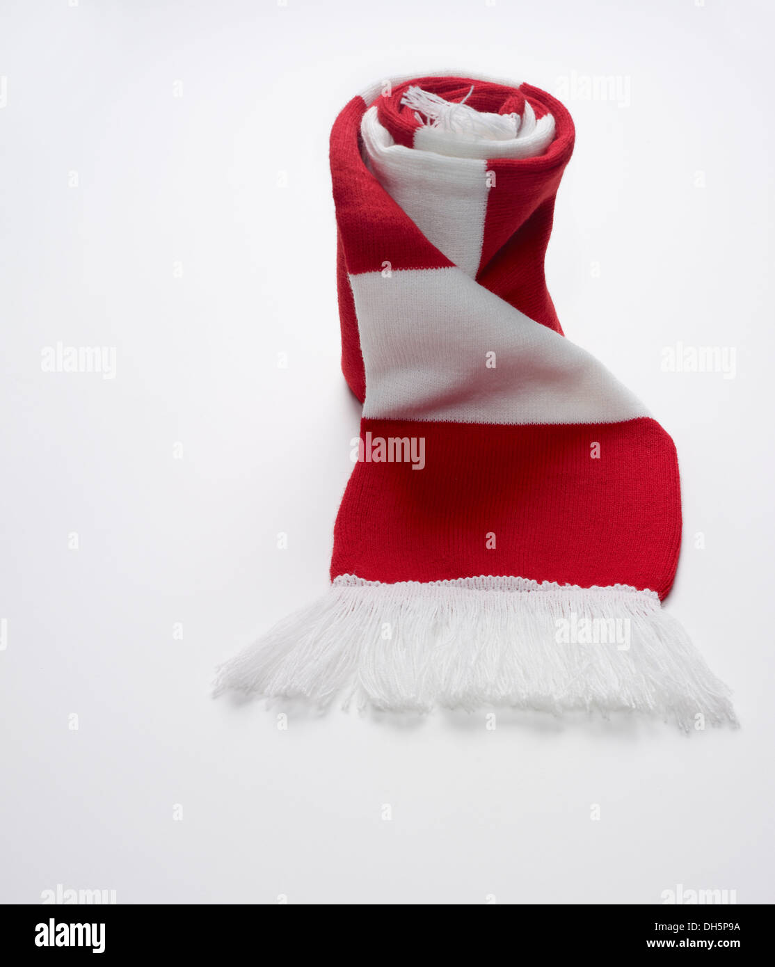 rolled up red and white football scarf on a white background Stock Photo