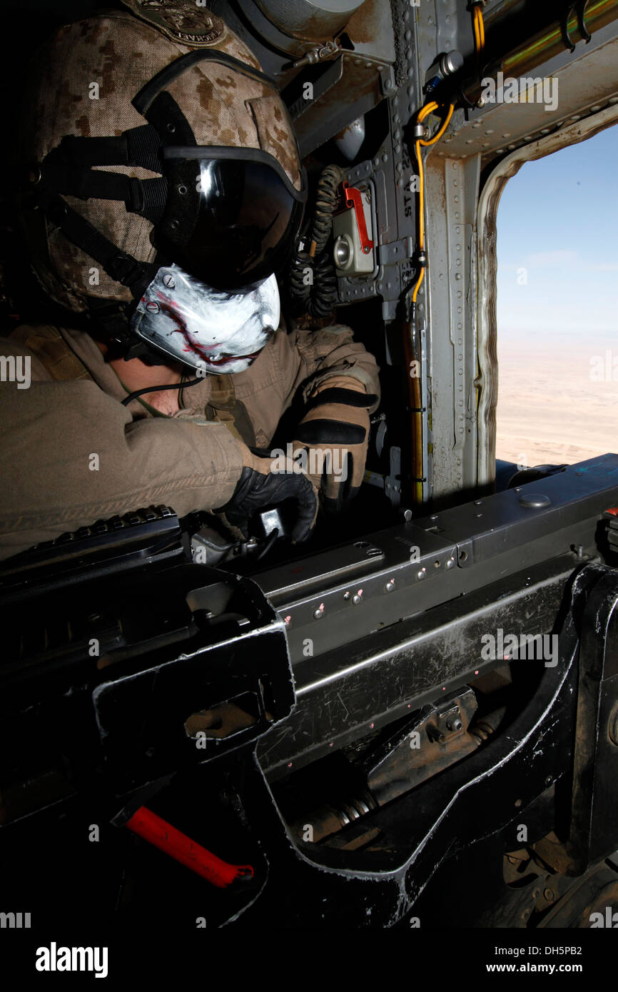 U.S. Marine Corps Cpl. Julio P. Ramos, an aerial observer with Marine Heavy Helicopter Squadron 462 (HMH-462) provides aerial security over Helmand province, Afghanistan, Oct. 28, 2013. HMH-462 supported Bravo Company, 1st Battalion, 9th Marine Regiment, Stock Photo