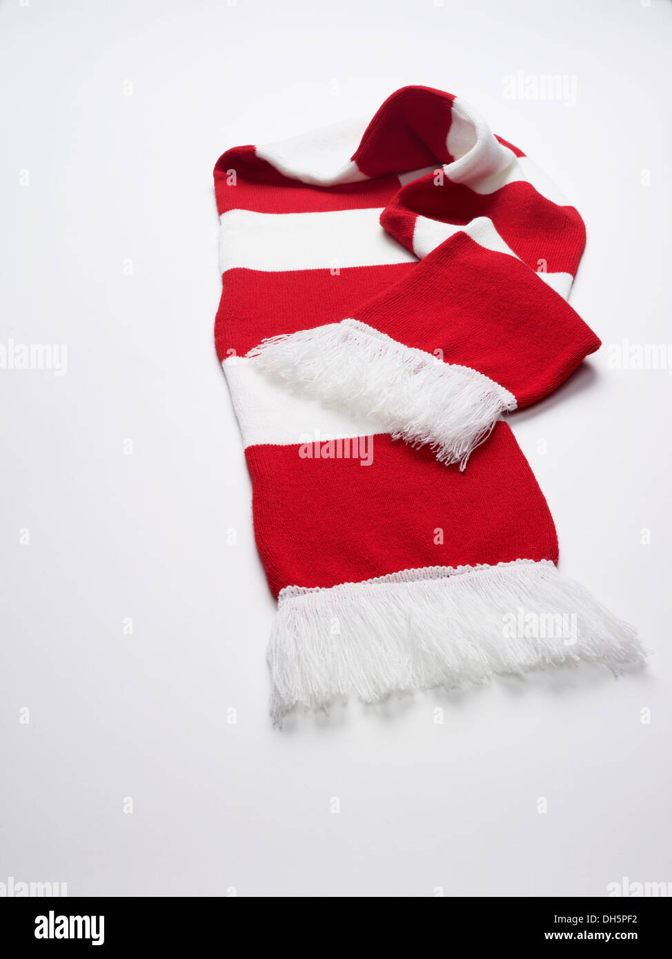 A red and white football scarf on a white background Stock Photo
