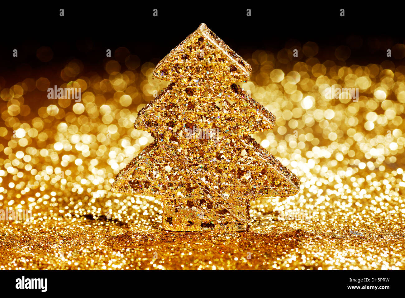 Golden christmas fir tree decoration on glitter background with black ...