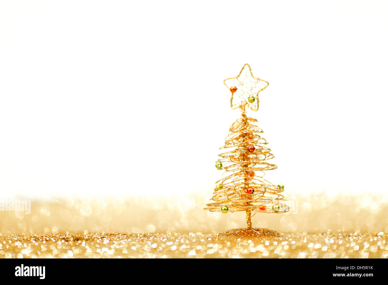 Golden christmas fir tree decoration on glitter background with white ...
