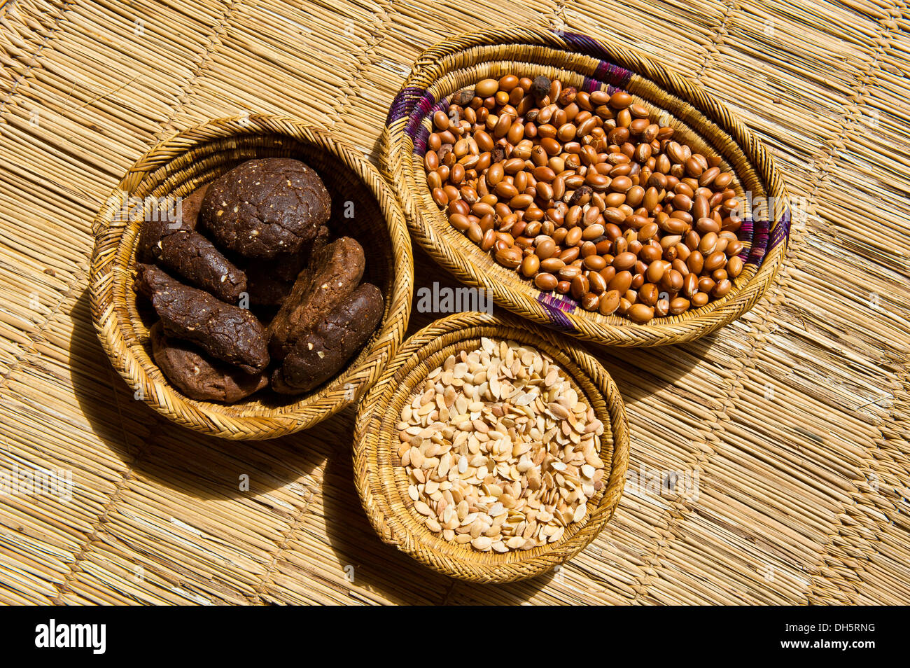 Preparation of argan oil, argan nuts, kernels and residues used as animal feed, in wicker baskets, Anti-Altas or Less Atlas Stock Photo