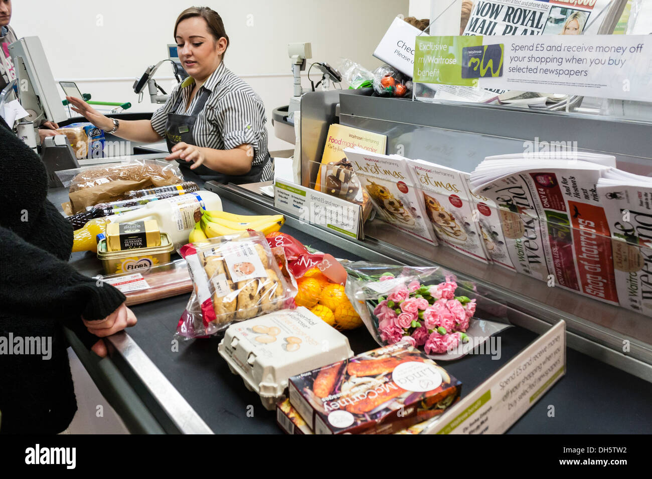 Waitrose supermarket checkout till as food products move along the belt. GB, UK Stock Photo