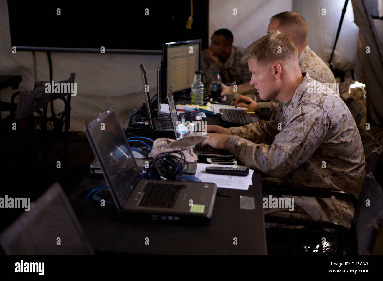 U.S. Marine Corps Lieutenant Col. Eric R. Olsen, Operations Officer with Marine Aircraft Group (MAG) 24, participates in operations during a simulated Command Operations Center (COC) at Marine Corps Base (MCB) Hawaii, Kaneohe Bay, October 25th, 2013. MAG- Stock Photo