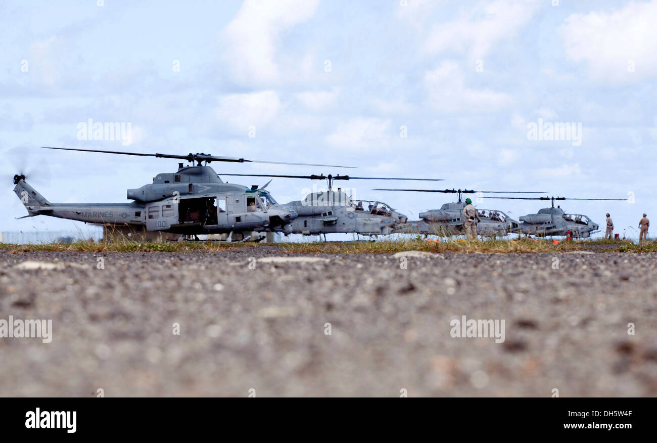 U.S. Marines with Marine Wing Support Detachment (MWSD) 24, finish refueling AH-1W Helicopters during an exercise which demonstrates MWSD-24s dual Forward Arming and Refueling Point (FARP) capabilities at Westfield Airstrip aboard Marine Corps Air Station Stock Photo