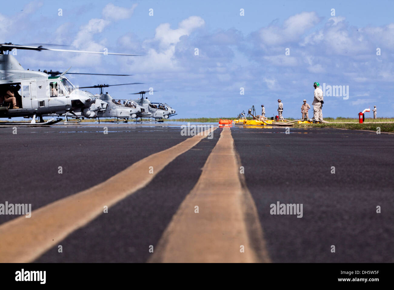 U.S. Marines with Marine Wing Support Detachment (MWSD) 24, waits to refuel landed helicopters during an exercise demonstrating Stock Photo