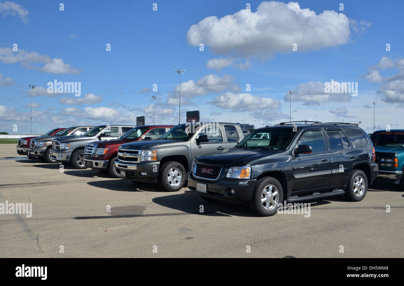 Big SUVs and pick up trucks line up an a USA parking lot Stock Photo