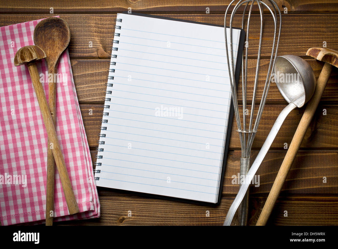 top view of recipe book with kitchenware on wooden table Stock Photo