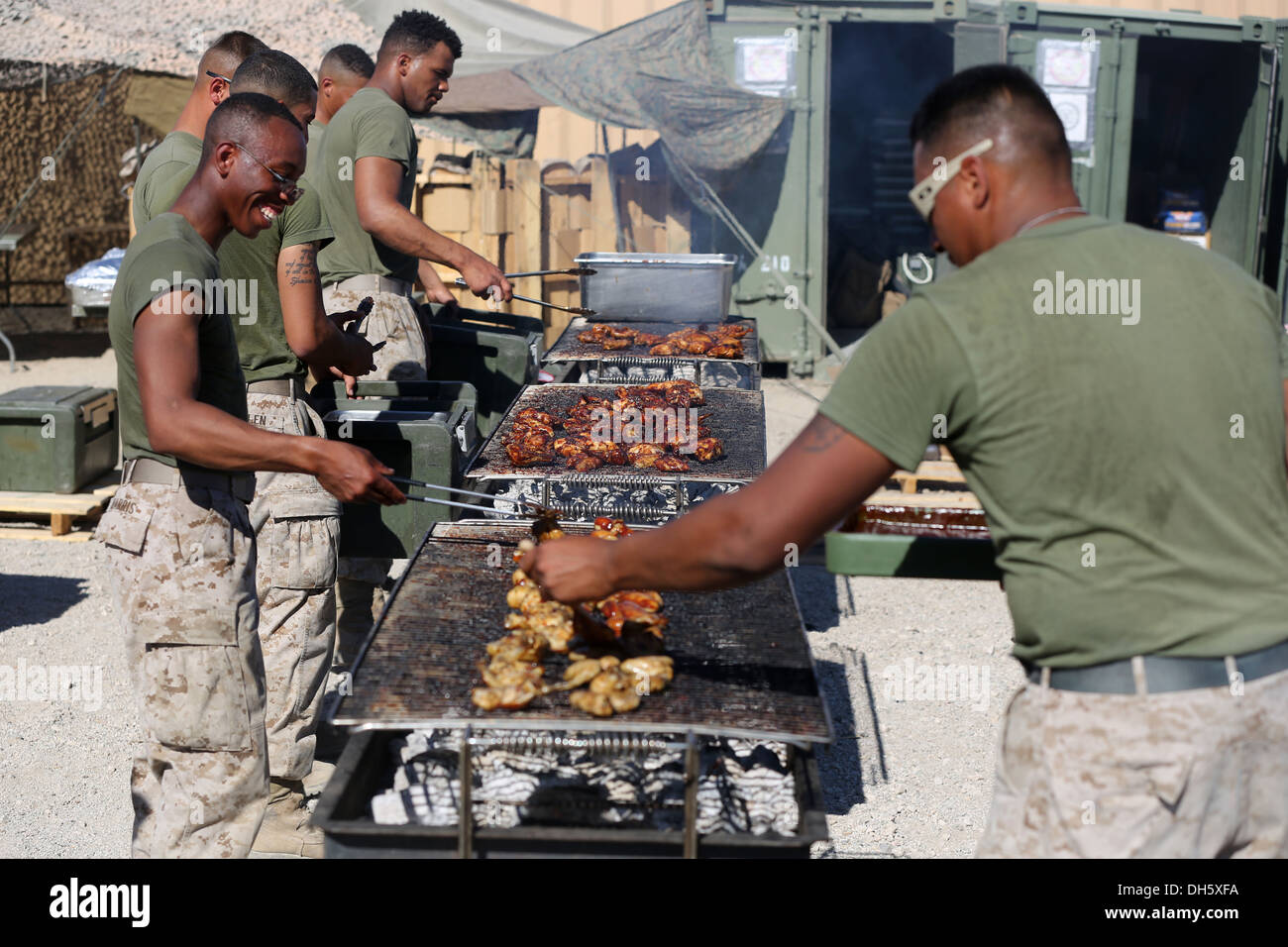 Marines with 1st Battalion, 7th Marine Regiment, grill chicken and steak before a warriors' meal here, Oct. 19, 2013. The battalion was rewarded with the meal for completing Weapons and Tactics Instructor course. WTI is held biannually and provides an opp Stock Photo