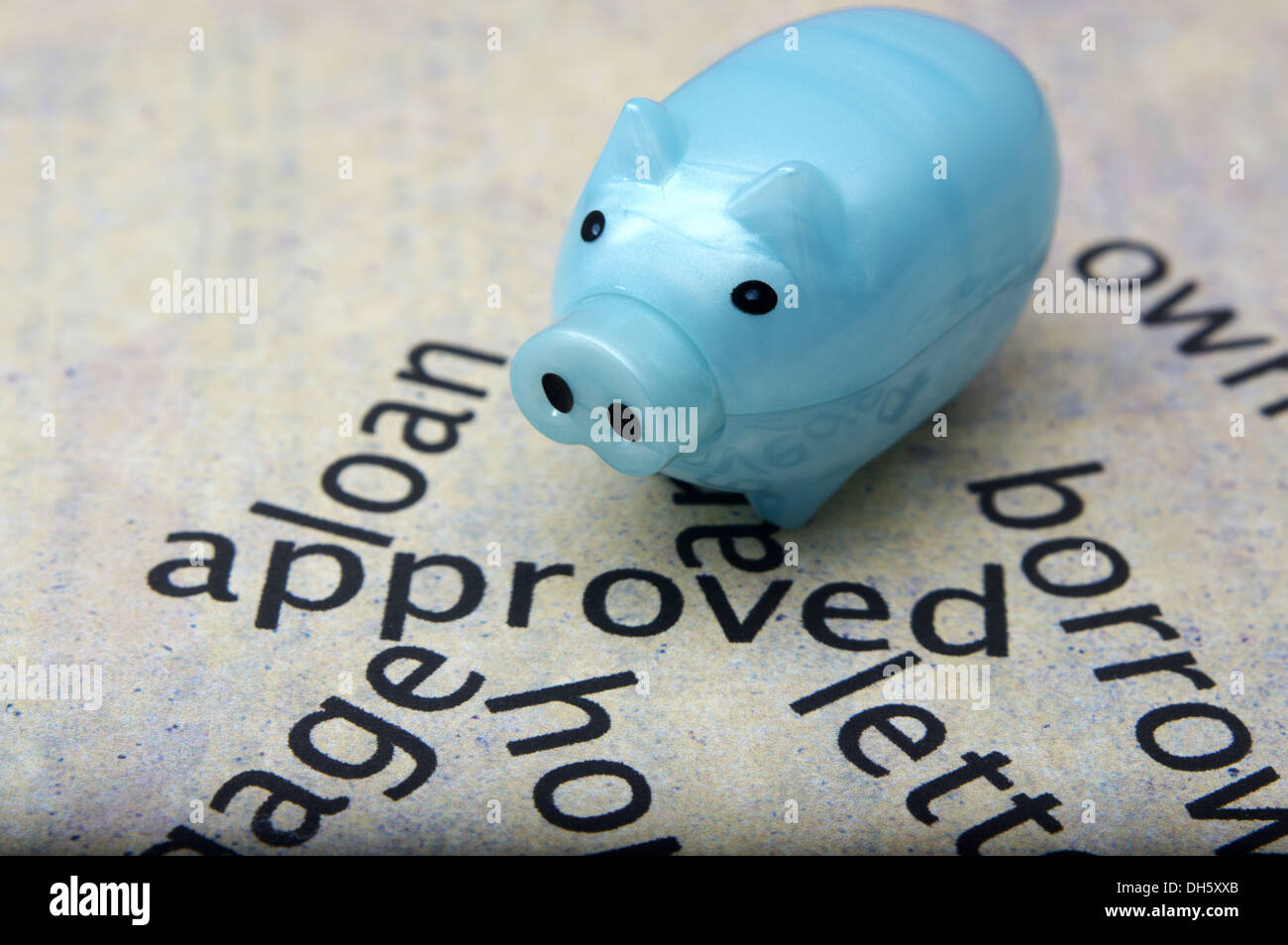 Approved text on paper with piggy bank Stock Photo