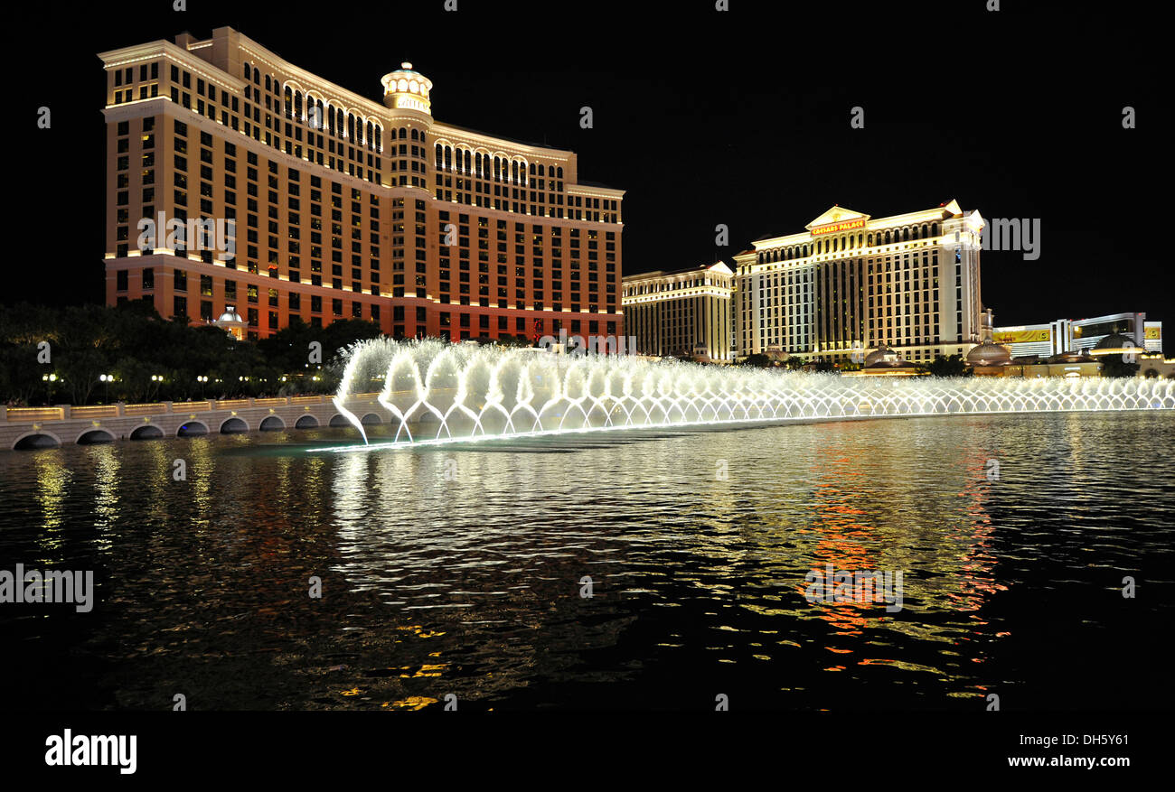 Night scene, water display in front of luxury hotels, casinos, Bellagio, Caesars Palace, The Mirage, Las Vegas, Nevada Stock Photo