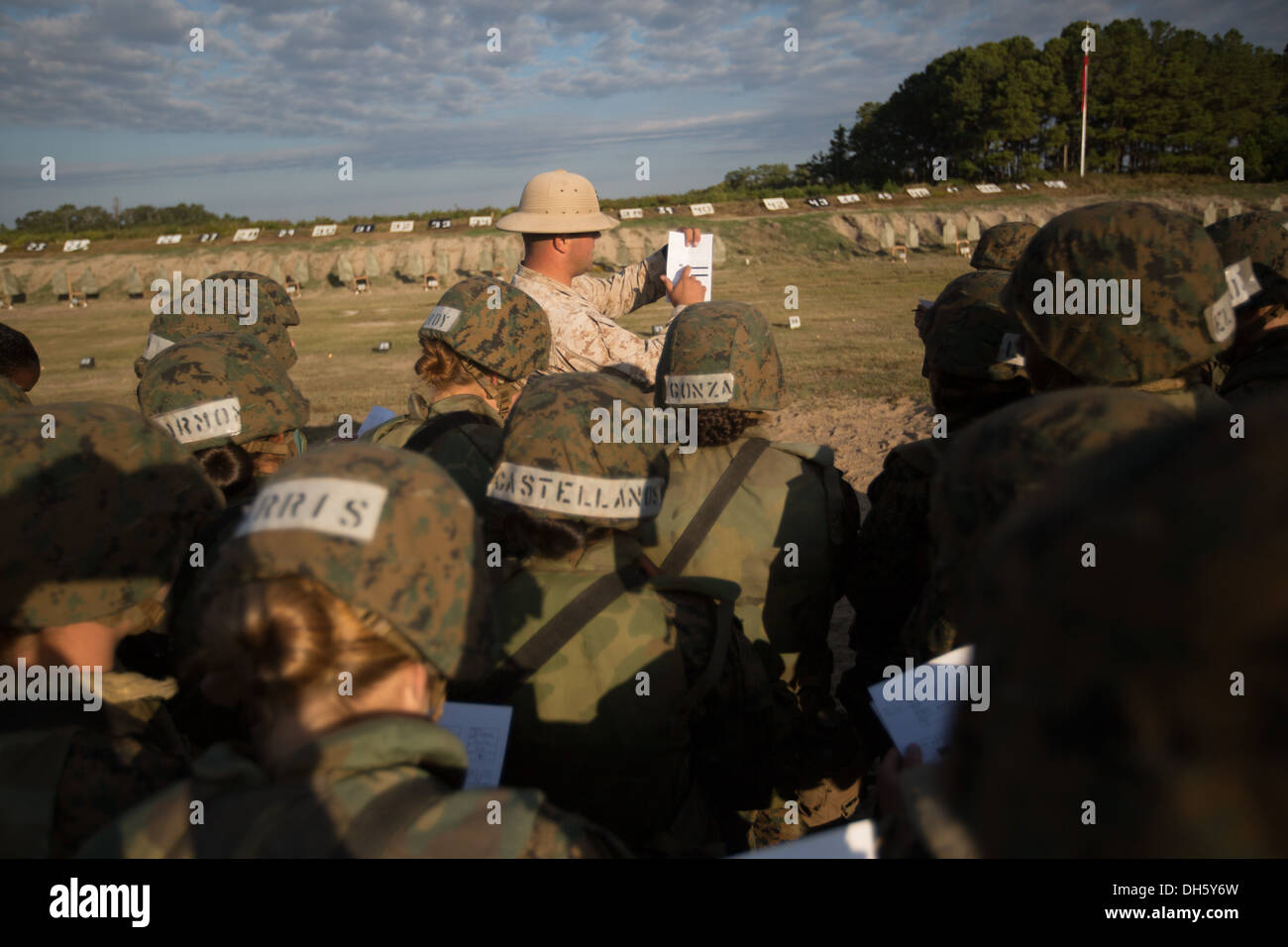 Sgt. Christopher Roberts, a marksmanship coach, shows recruits of November Company, 4th Recruit Training Battalion, how to fill Stock Photo