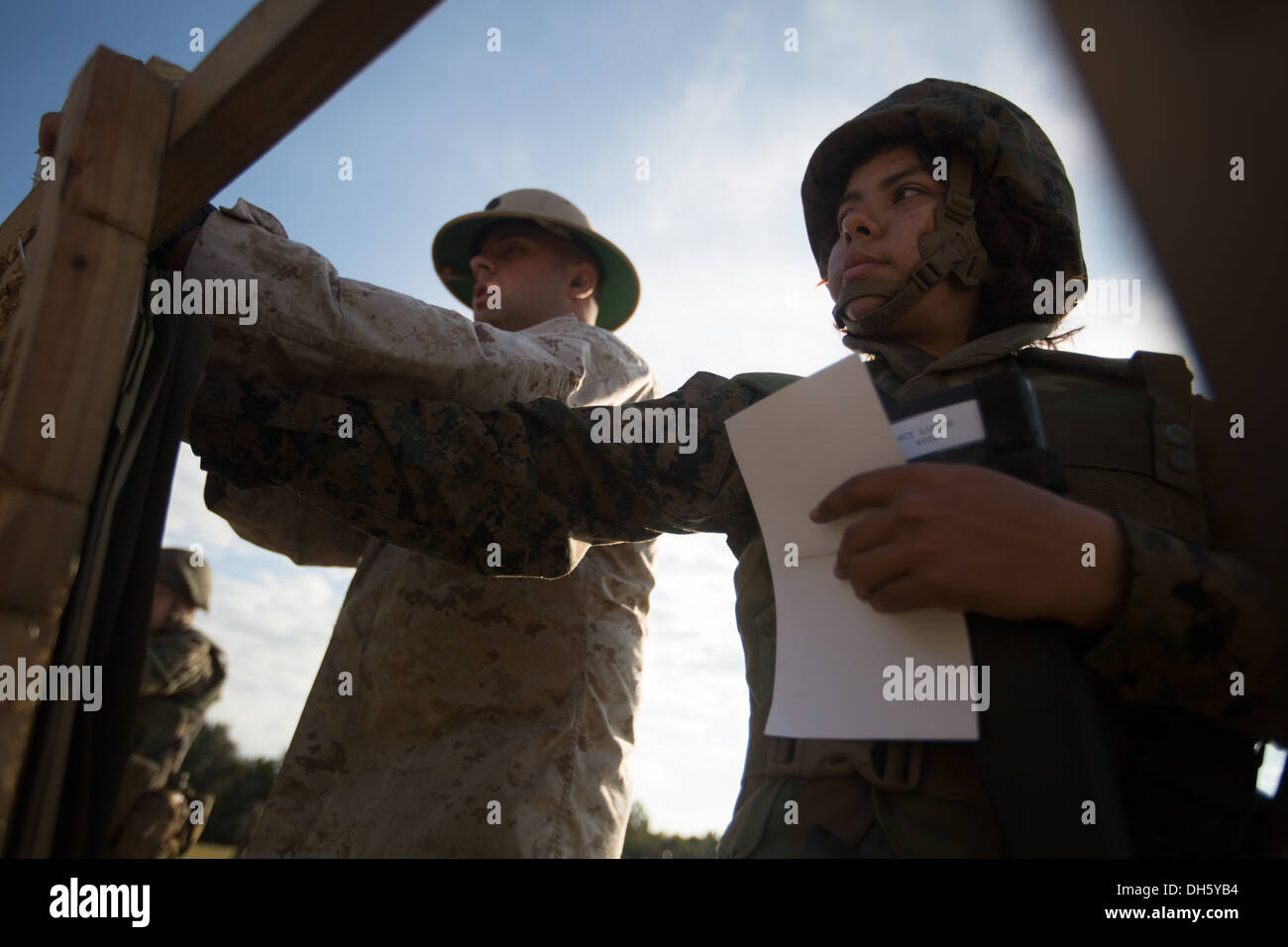 Sgt. Christopher Roberts, a marksmanship coach, discusses Rct. Carla Lizano’s score with her Oct. 25, 2013, on Parris Island, S. Stock Photo