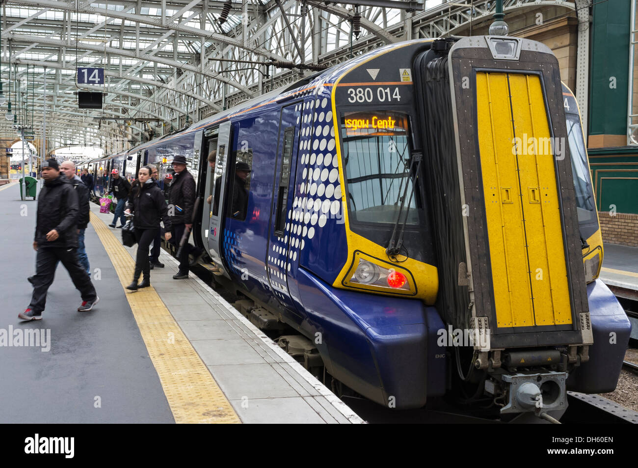 Passengers getting off an intercity train at Glasgow Central Railway