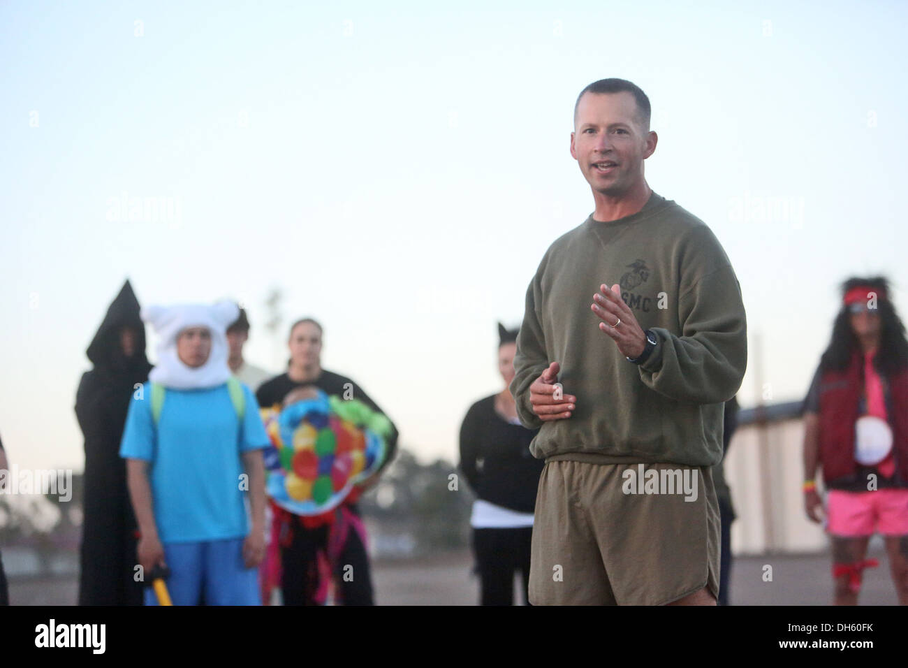 Maj. Brian J. Brauer, commanding officer, Headquarters Company, Combat Logistics Regiment 17, 1st Marine Logistics Group, motivates Marines at the end of a Halloween-themed physical training circuit aboard Camp Pendleton, Calif., Oct. 30, 2013. The event' Stock Photo