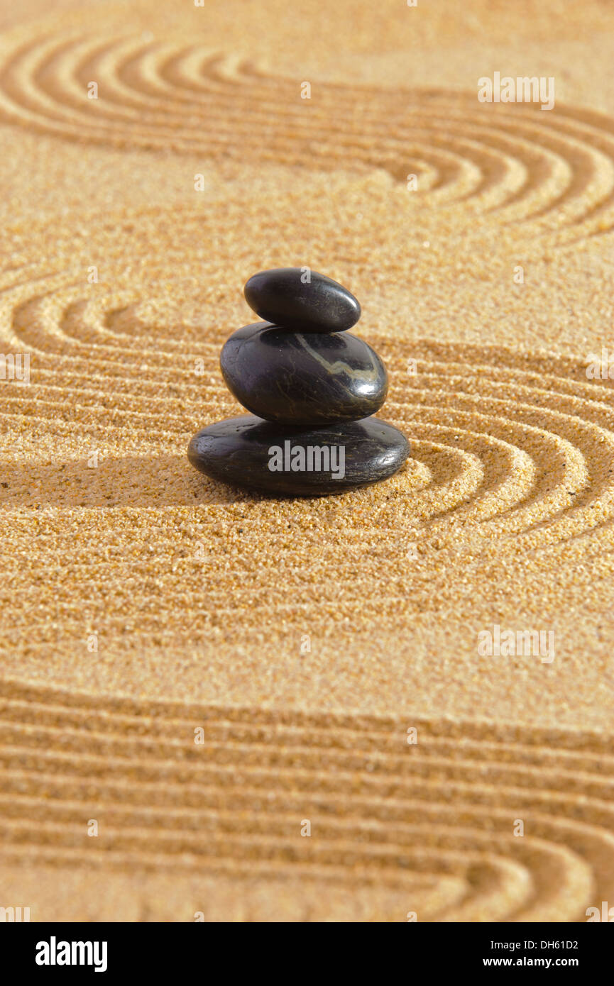Japanese zen garden with stacked stones in sand Stock Photo Alamy