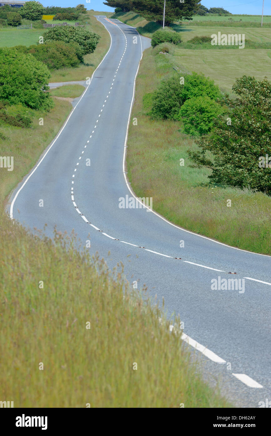 empty road running through rural countryside Stock Photo