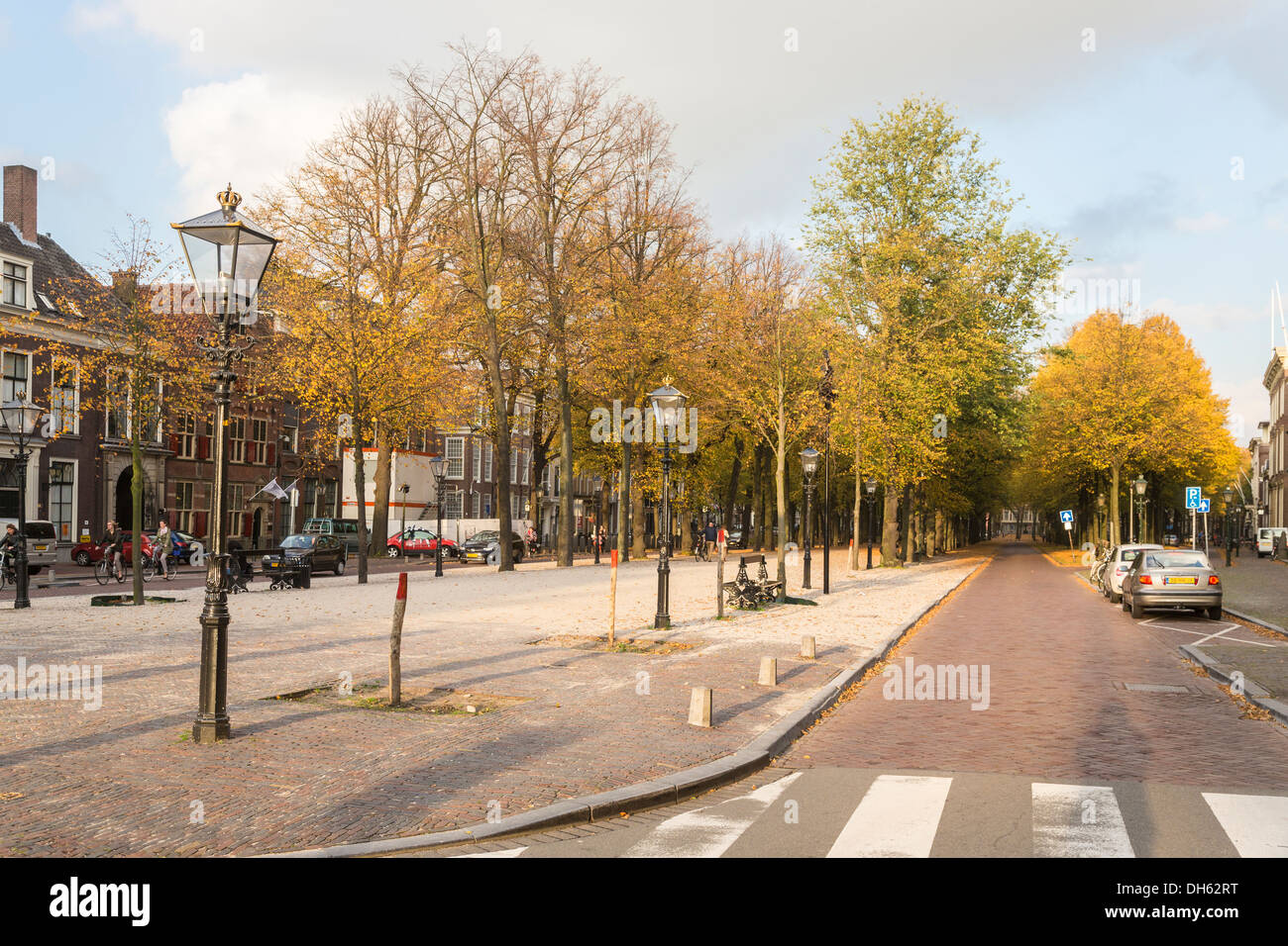 Lange Voorhout street scene in The Hague, Holland, with trees with golden autumn colours and traditional black lampposts Stock Photo