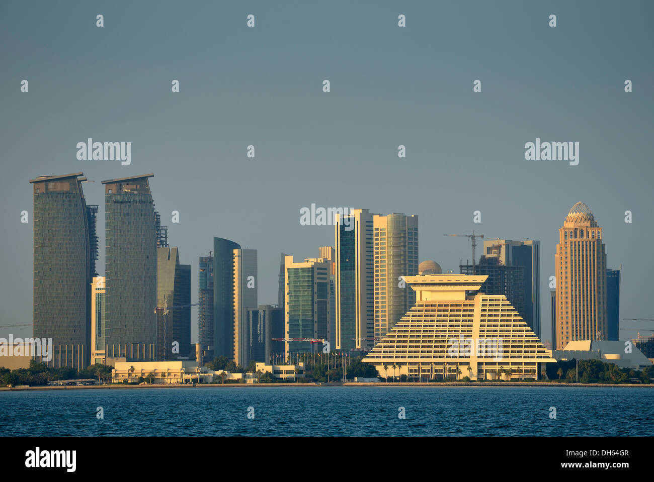Skyline of Doha with Al Fardan Residences Tower, Doha Bank Tower, Sheraton Doha Hotel, Four Seasons Hotel, in the evening light Stock Photo