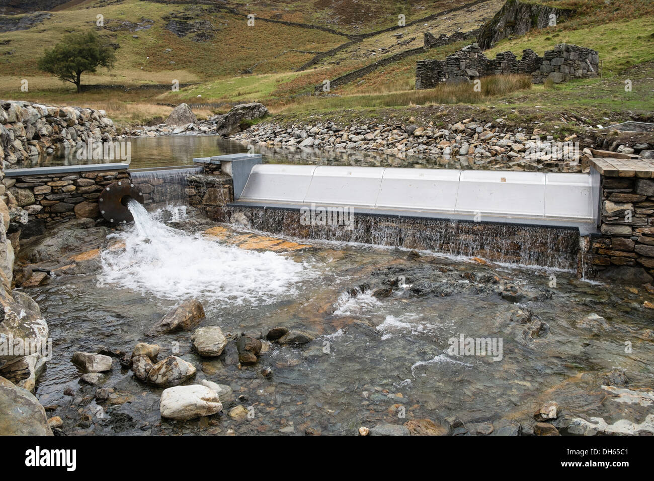 Weir on Afon Llan river by Watkin Path in Snowdonia gathers water for National Trust's small hydro-electric power plant scheme. Cwm Llan Wales UK Stock Photo