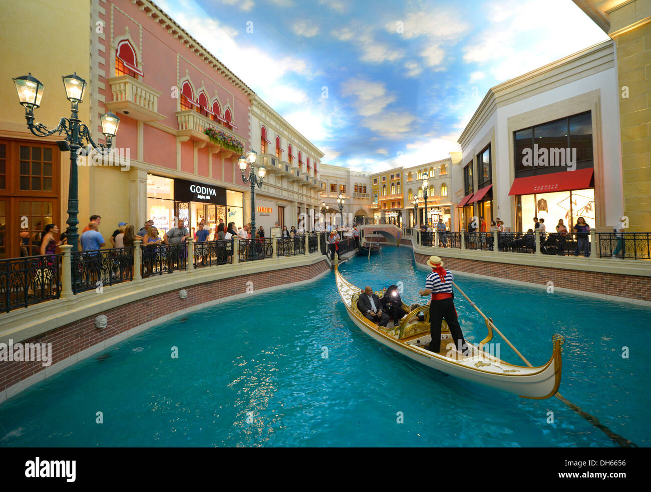 Gondolier in a Gondola with tourists in a replica of Venetian streets under an artificial sky, Grand Canal, 5-star luxury hotel Stock Photo