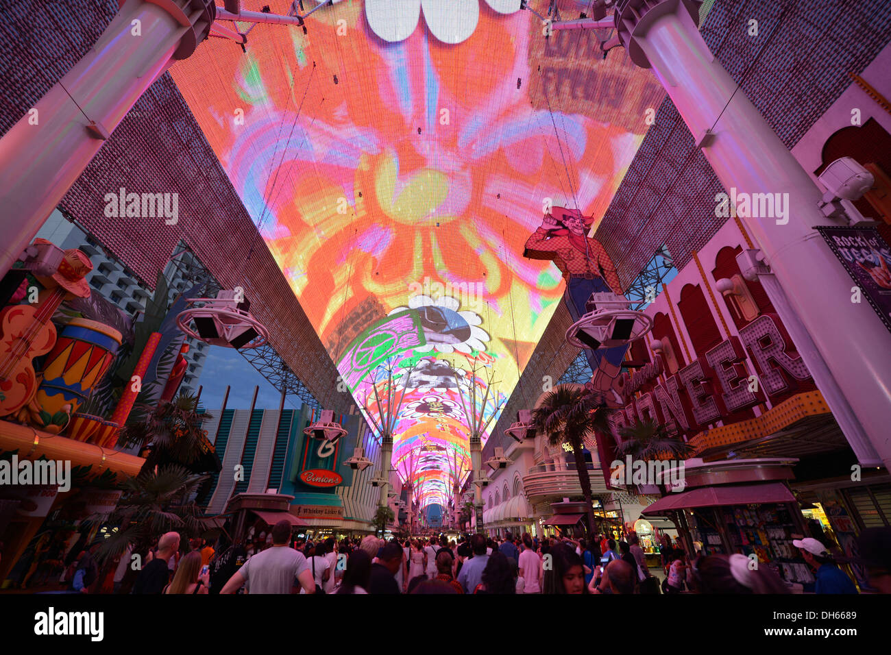 Tourists marvelling at the laser show in the neon dome of the Fremont