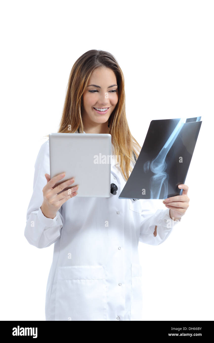 Female doctor comparing a tablet image with a radiography isolated on a white background Stock Photo