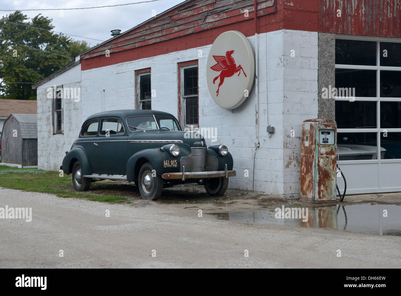 Classic Car parked alongside a vintage Mobil Gas station in rural
