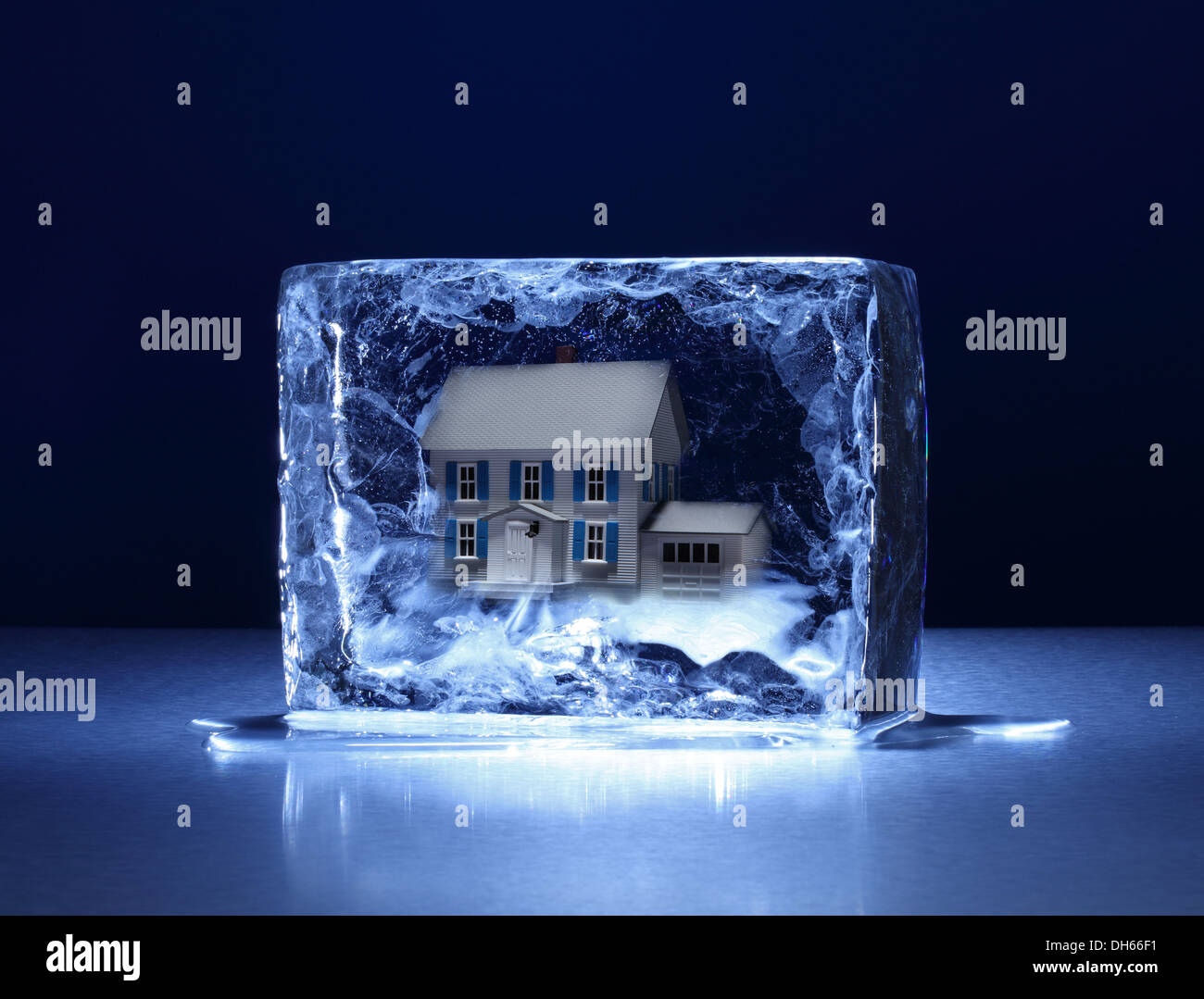 A model house frozen in a clear block of ice Stock Photo