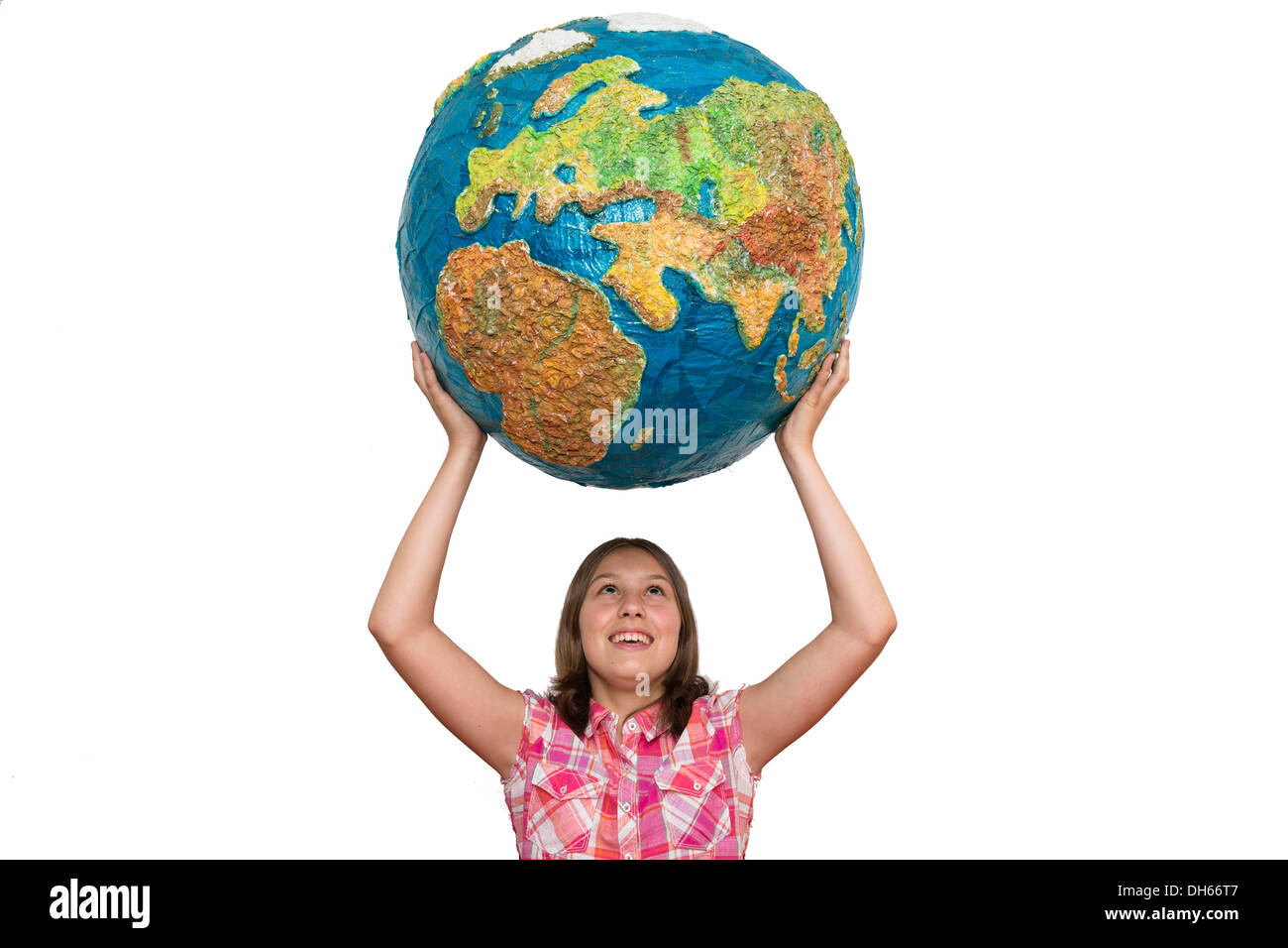 Girl holding up a large globe, Germany Stock Photo