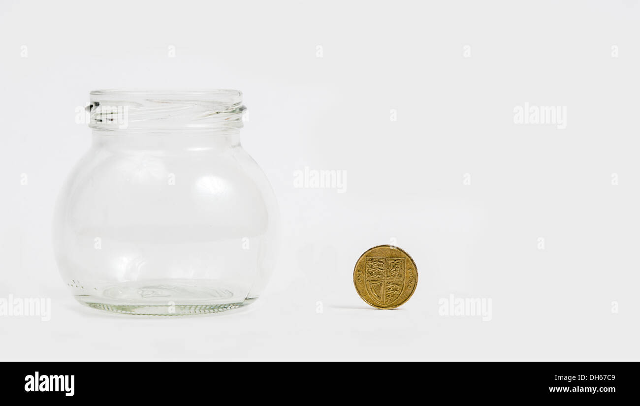 pound coin by empty jar Stock Photo