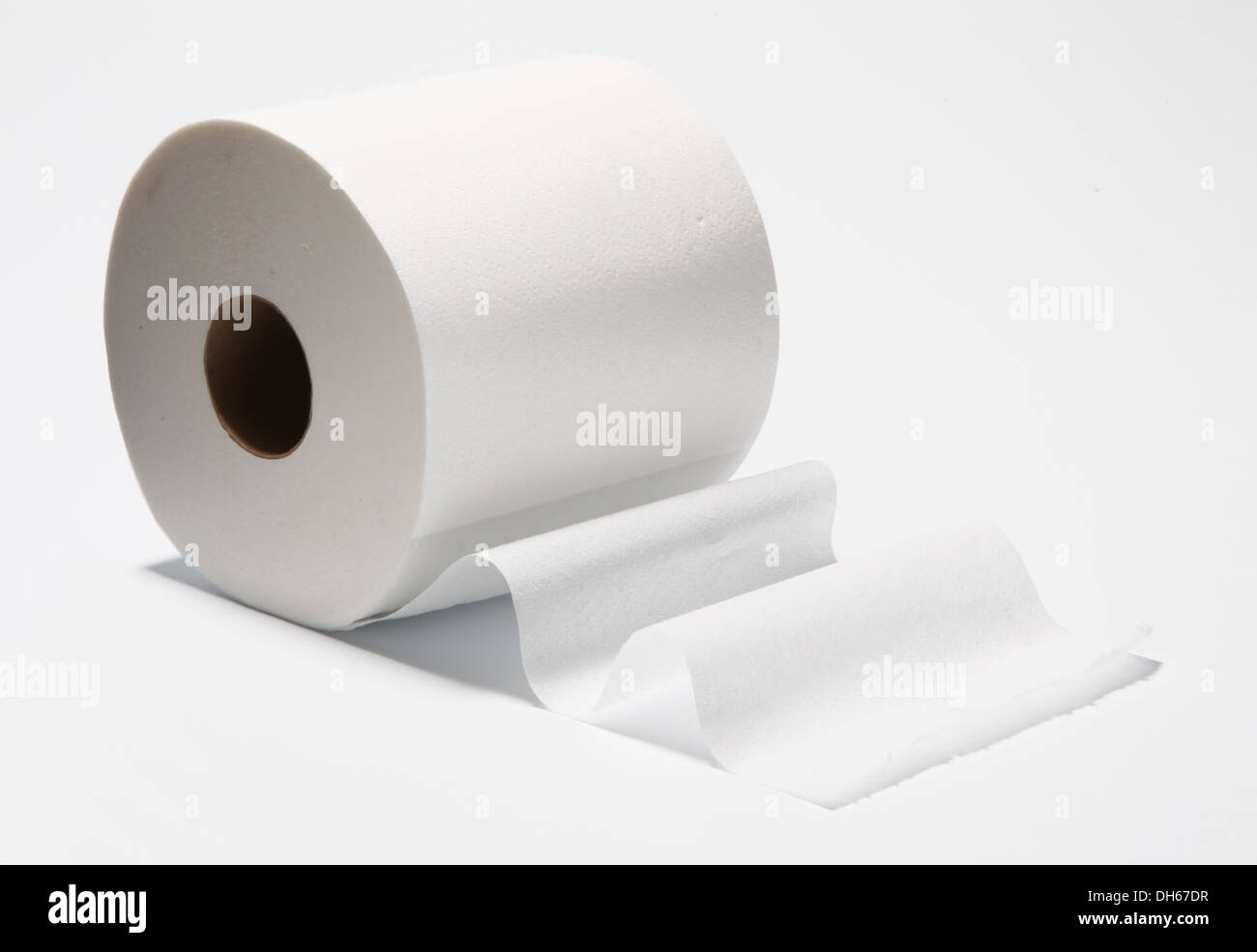 A slightly unrolled roll of white bathroom tissue / toilet paper Stock Photo