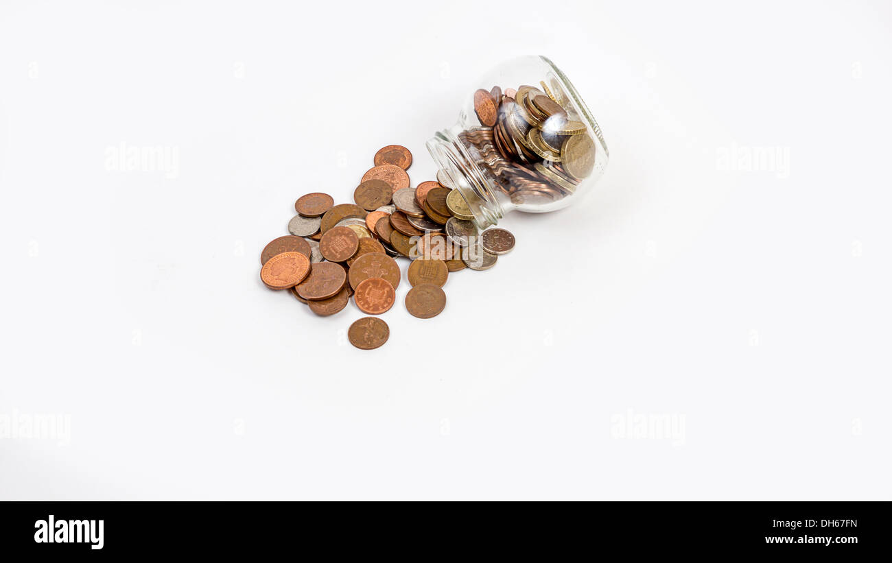 coins spilt from a jar Stock Photo