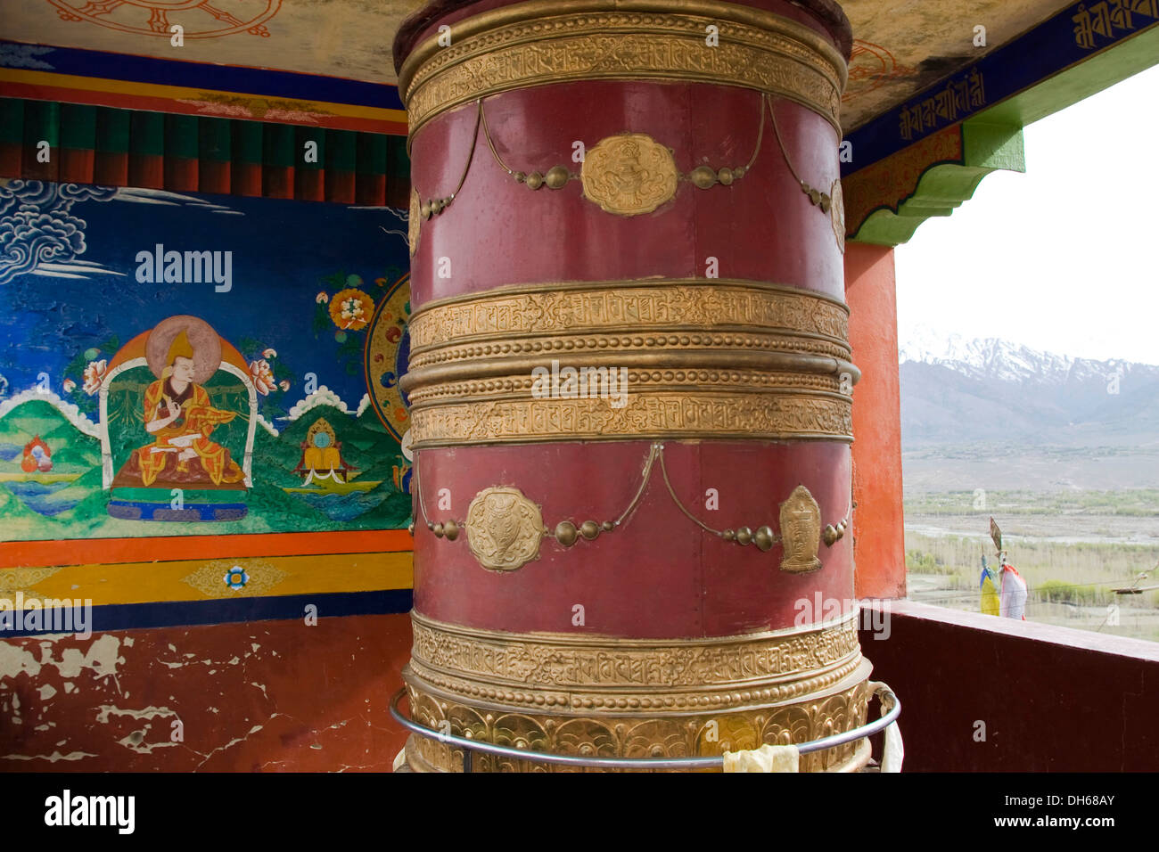 Tibetan Buddhist monastery with a prayer wheel and a wall relief in the