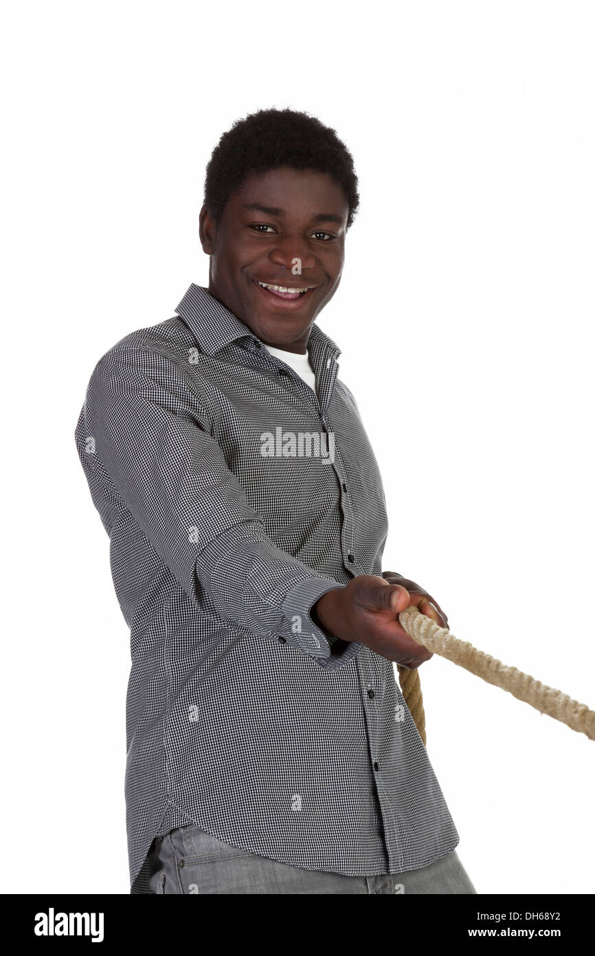Young black man pulling on a rope Stock Photo