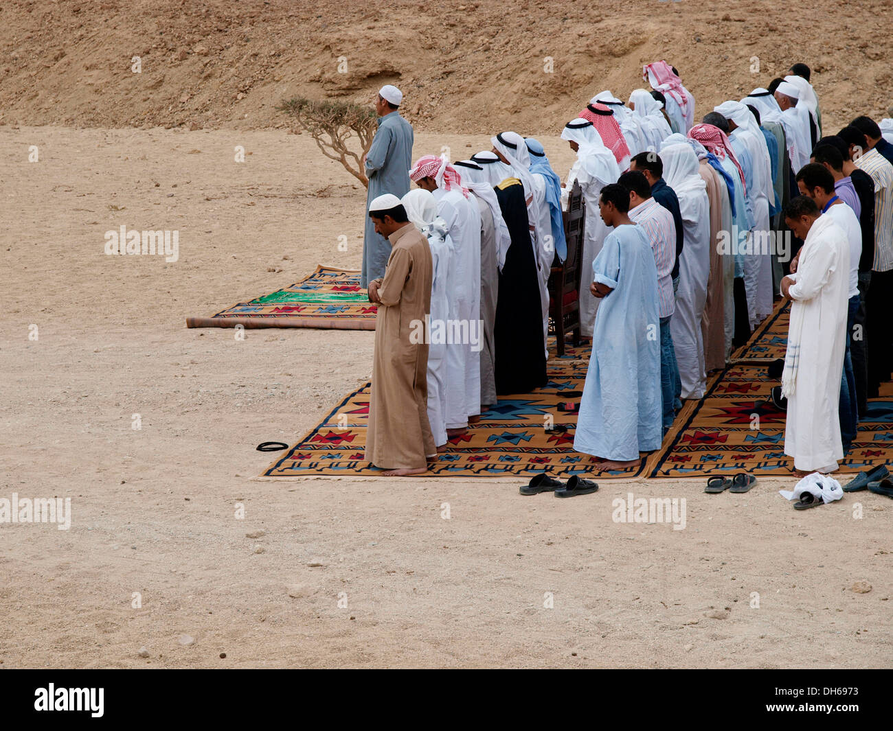 Allah akbar - Allah is great, Bedouins facing toward Mecca in prayer, desert peoples from Egypt meeting in Wadi el Gamal Stock Photo