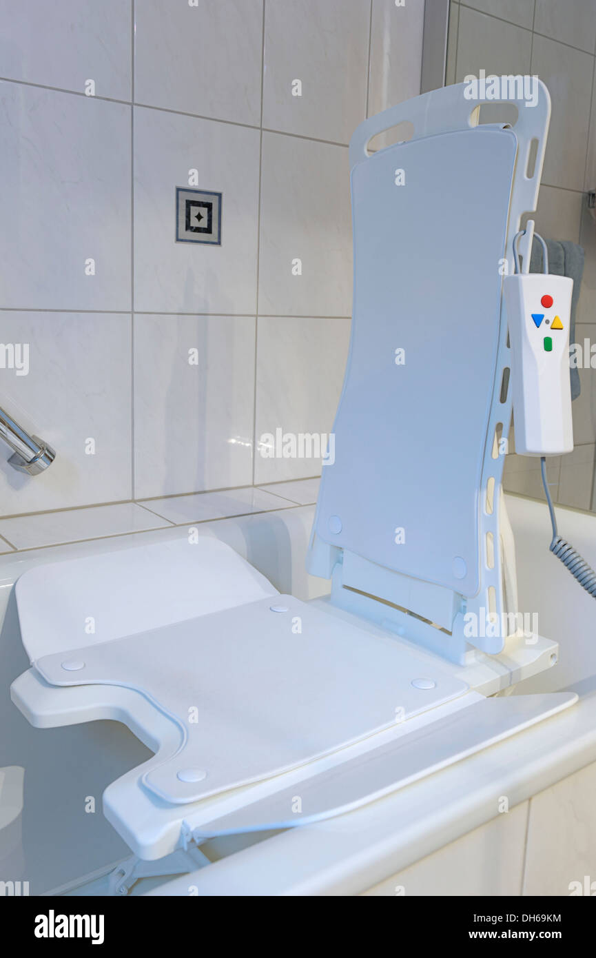 Battery-powered bath lift with an electric motor and a remote control, facility for outpatient care to care for dependent people Stock Photo
