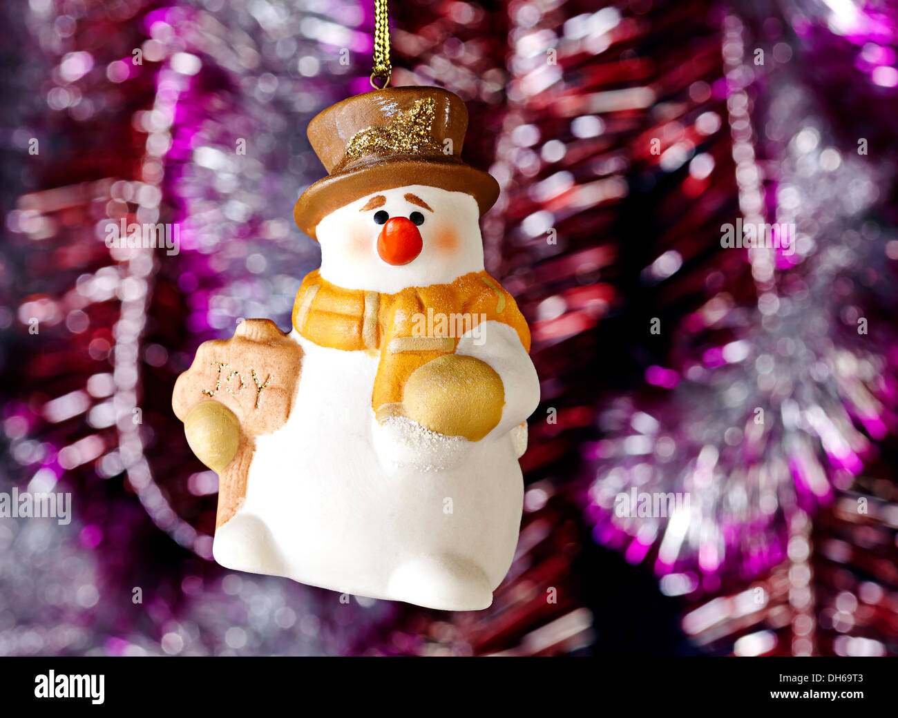 Happy Christmas snowman, tinsel as background. Selective focus Stock Photo