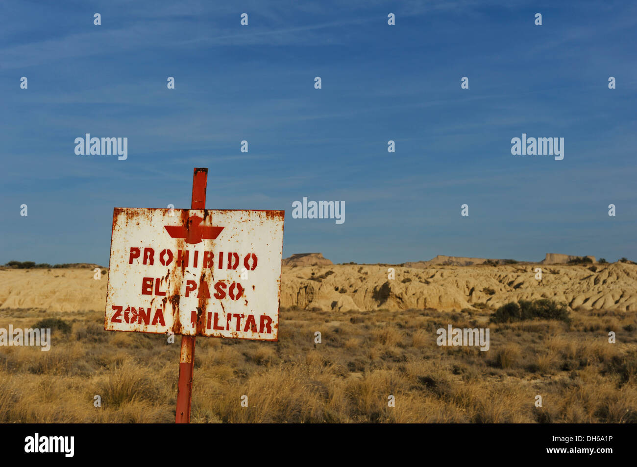 Sign, military zone, characteristic bizarre landscape of ocher clay, semidesert Bardenas Reales, UNESCO Biosphere Reserve Stock Photo