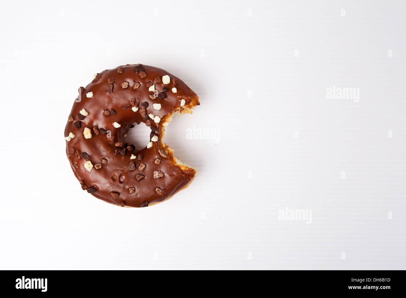 Frosted glazed Donut with chocolate sprinkles Stock Photo