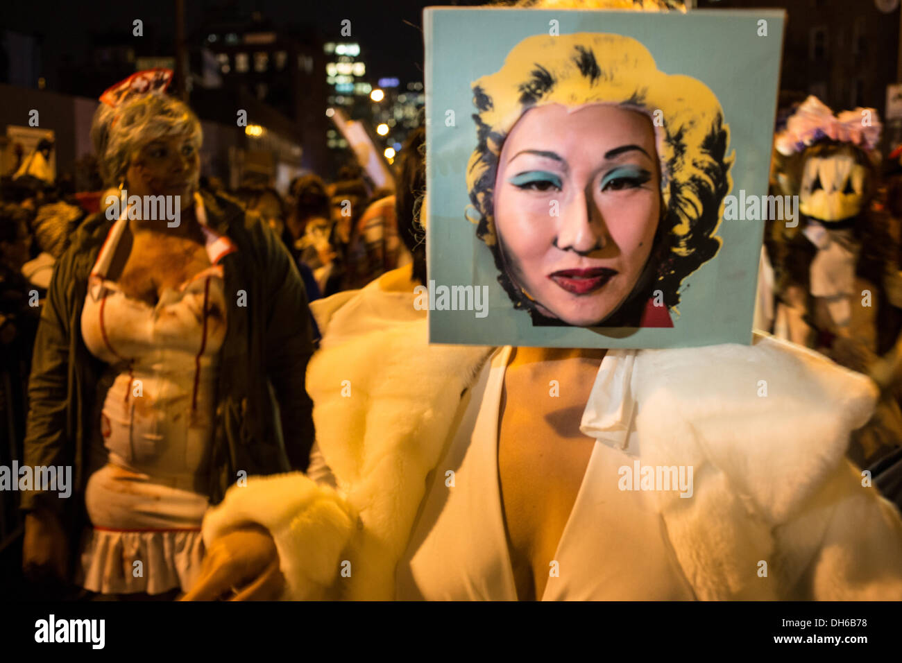 New York, NY, 31 October 2013.A woman of Asian descent wears a replica of an Andy Warhol portrait of Marilyn Monroe with her actual face replacing Monroe's face in the Greenwich Village Halloween Parade. 2013 is the 40th anniversary of the parade, which was cancelled in 2012 because of hurricane Sandy. Credit:  Ed Lefkowicz/Alamy Live News Stock Photo