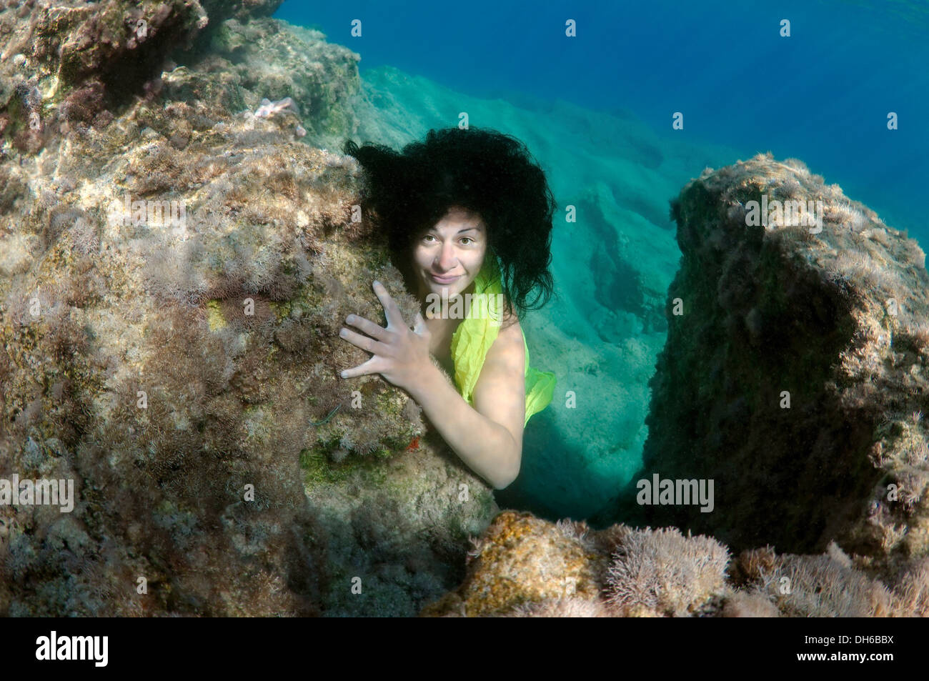 A young woman with big hair posing in Aegean Sea underwater. Greece Stock Photo