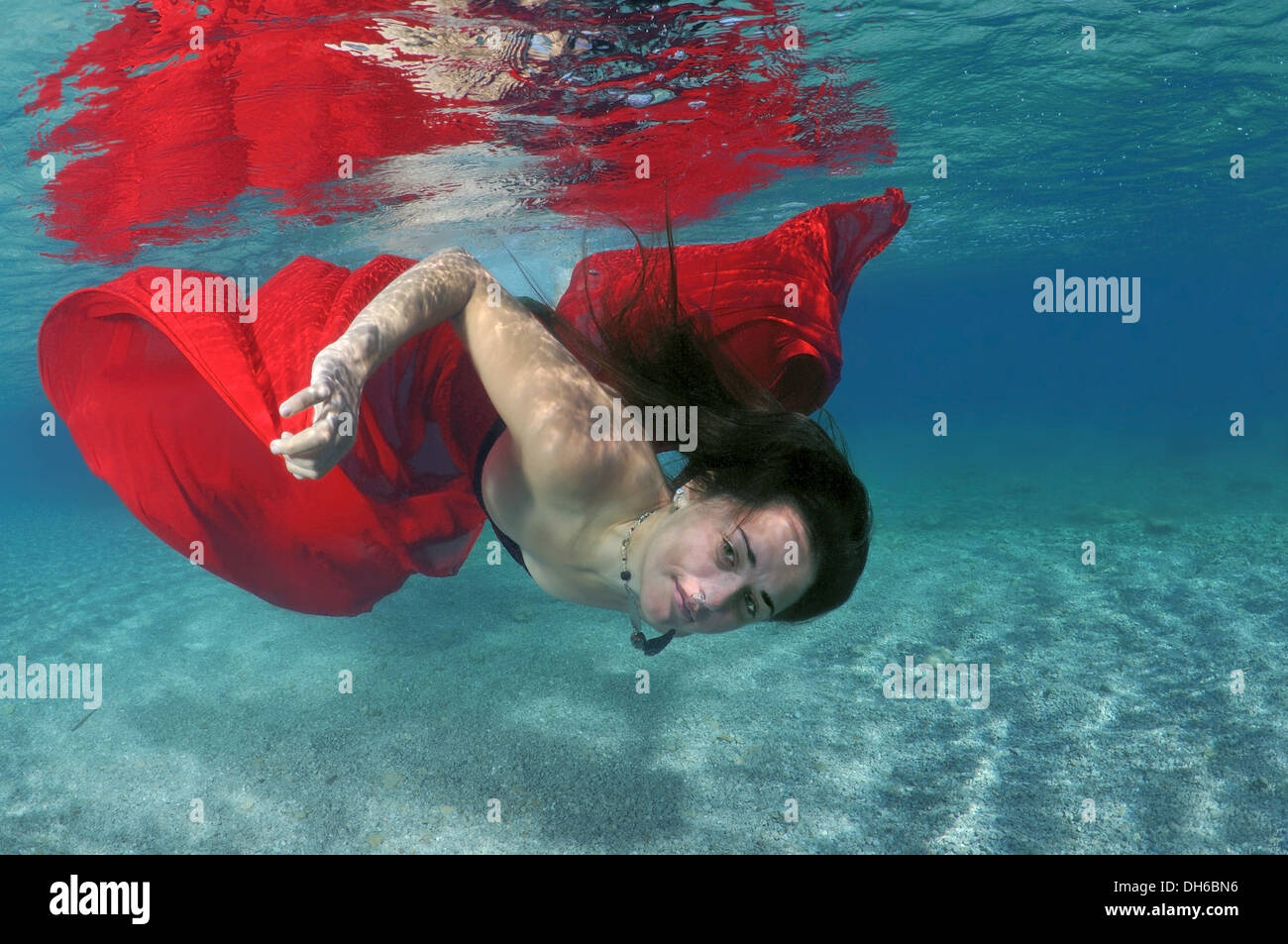 A young woman with big hair posing in Aegean Sea underwater. Greece Stock Photo