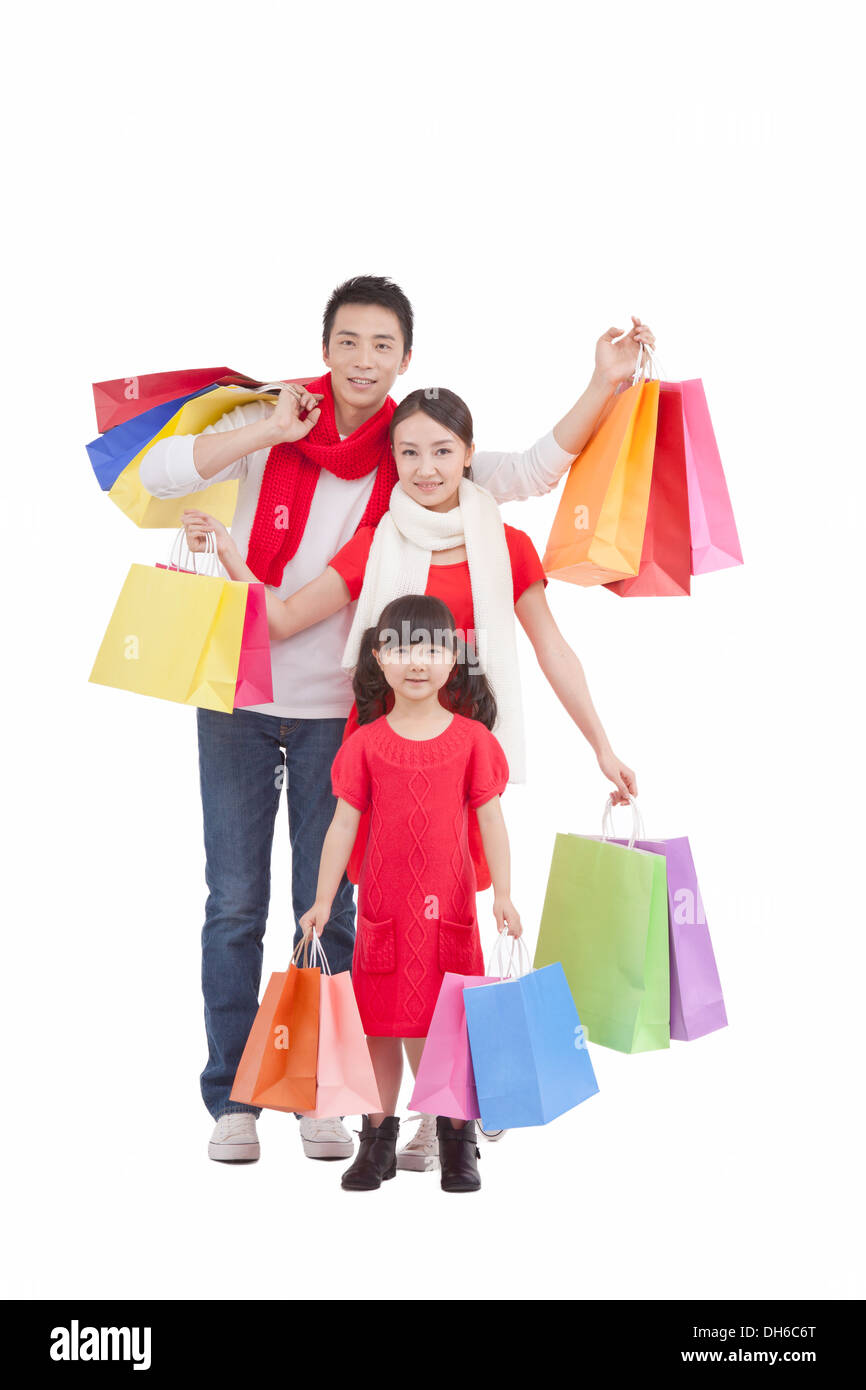 A family holding shopping bags Stock Photo - Alamy